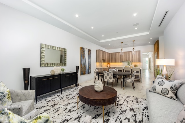 living room featuring a tray ceiling