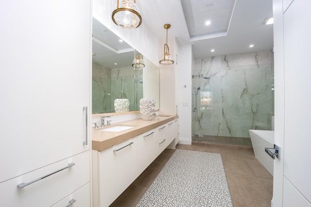 bathroom with a shower with door and vanity