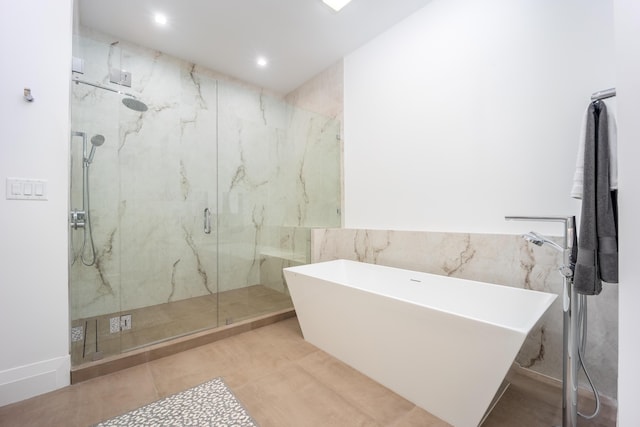 bathroom featuring tile walls, tile patterned floors, and plus walk in shower