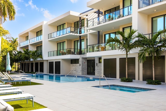 view of swimming pool with a community hot tub