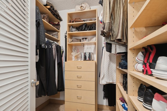 walk in closet with tile patterned floors