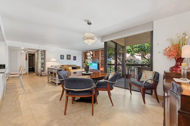 dining room with floor to ceiling windows, light tile patterned floors, and an inviting chandelier