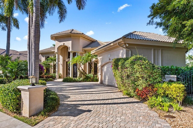 mediterranean / spanish-style home with a garage