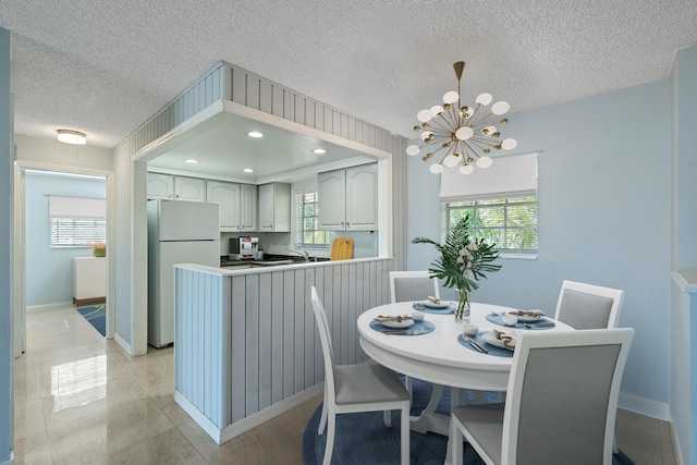 148 Yacht Club Dr Unit 12, North Palm Beach, FL 33408 - dining space featuring a textured ceiling and a chandelier