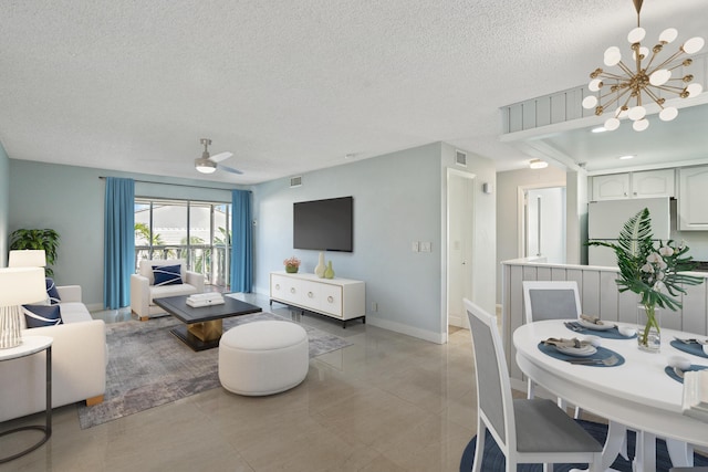 148 Yacht Club Dr Unit 12, North Palm Beach, FL 33408 - living room with a textured ceiling, a chandelier, light tile patterned floors, and ceiling fan
