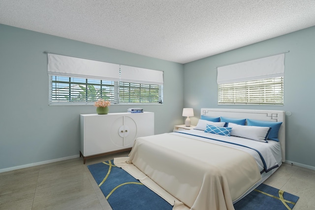 148 Yacht Club Dr Unit 12, North Palm Beach, FL 33408 - bedroom featuring a textured ceiling and baseboards