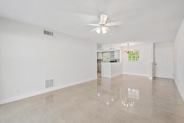 148 Yacht Club Dr Unit 12, North Palm Beach, FL 33408 - unfurnished living room featuring a chandelier, a ceiling fan, a textured ceiling, and light tile patterned floors