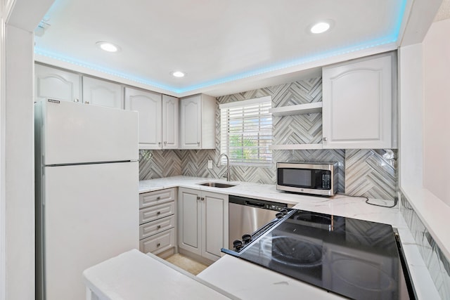 148 Yacht Club Dr Unit 12, North Palm Beach, FL 33408 - kitchen featuring stainless steel appliances, backsplash, recessed lighting, and light stone countertops