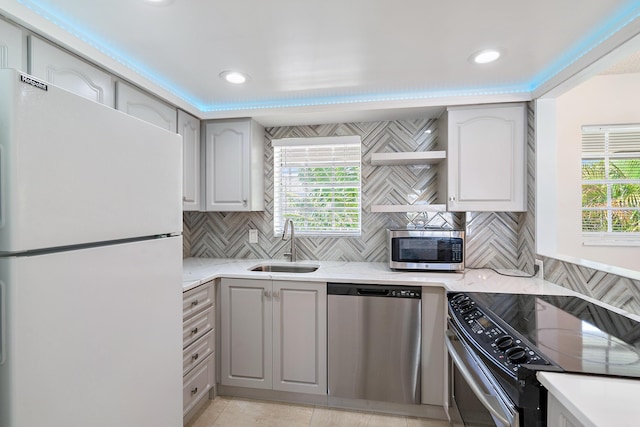 148 Yacht Club Dr Unit 12, North Palm Beach, FL 33408 - kitchen with stainless steel appliances, tasteful backsplash, plenty of natural light, and recessed lighting