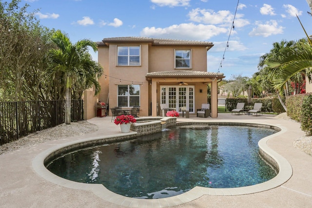 view of swimming pool featuring an in ground hot tub, ceiling fan, a patio, and french doors