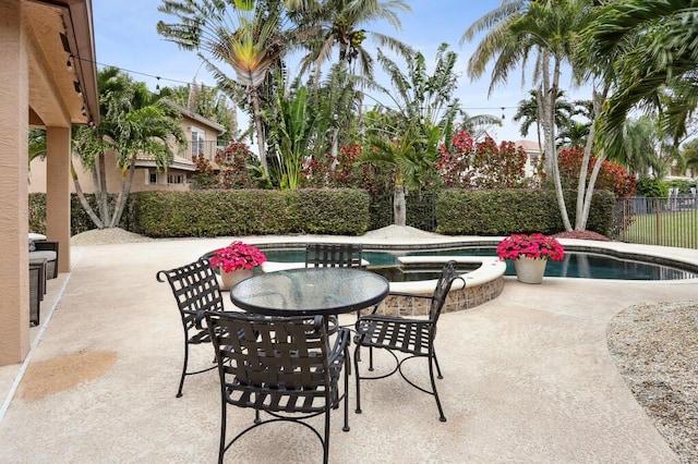 view of patio / terrace featuring a pool with hot tub