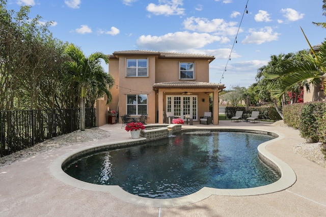 view of swimming pool with french doors, an in ground hot tub, ceiling fan, and a patio