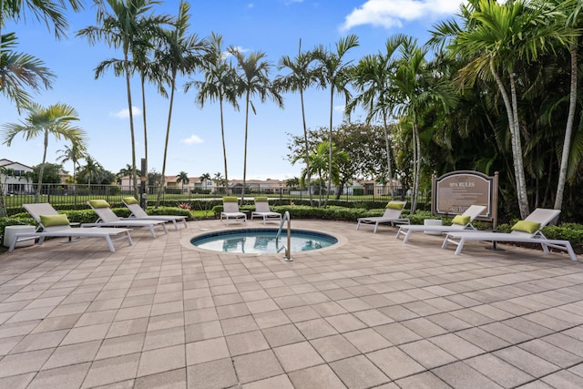 view of swimming pool with a hot tub and a patio area