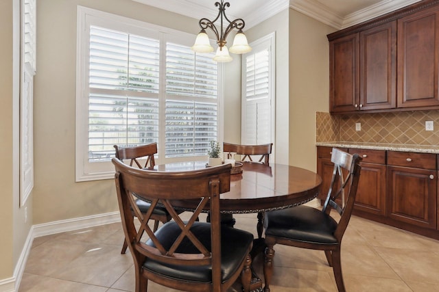 tiled dining room featuring an inviting chandelier and crown molding