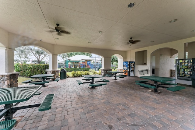 view of patio with a playground and ceiling fan