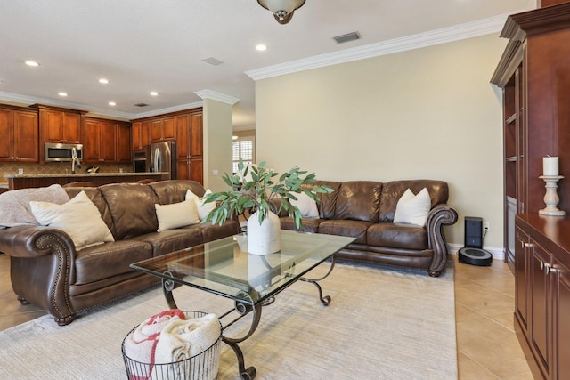 living room with ornamental molding and light tile patterned flooring