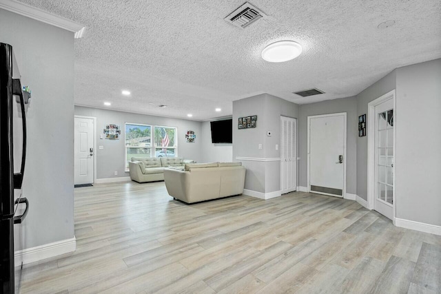 living room featuring a textured ceiling and light wood-type flooring