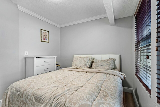 bedroom with ornamental molding, hardwood / wood-style floors, and a textured ceiling