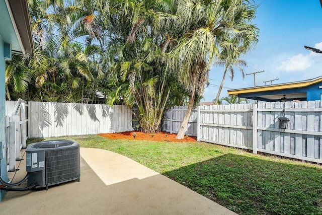 view of yard featuring cooling unit and a patio