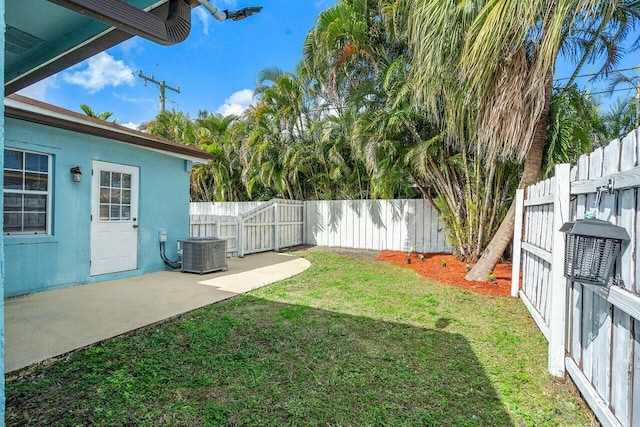 view of yard with cooling unit and a patio