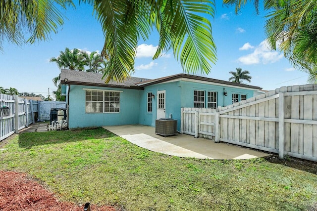 back of house featuring a yard and a patio area