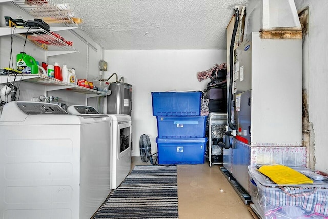 clothes washing area with separate washer and dryer, water heater, and a textured ceiling