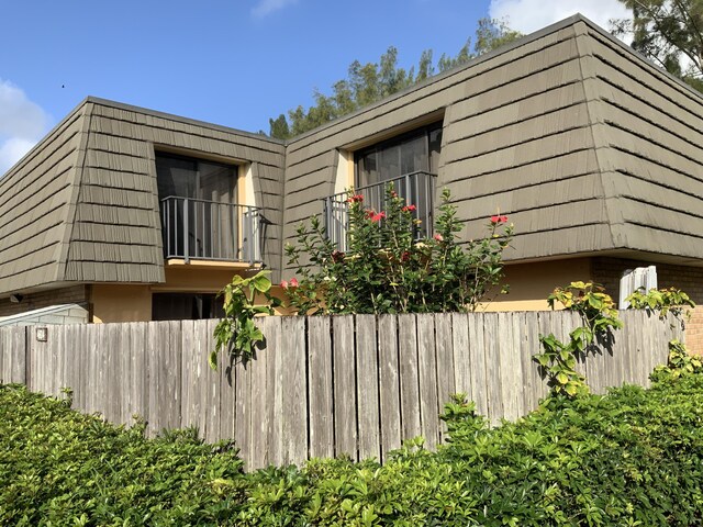 view of side of property featuring a balcony