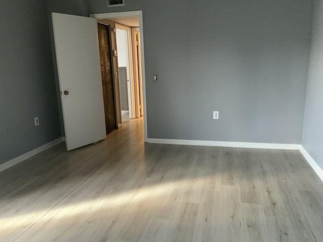 spare room with light hardwood / wood-style floors