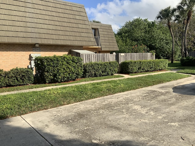 view of property exterior with a lawn