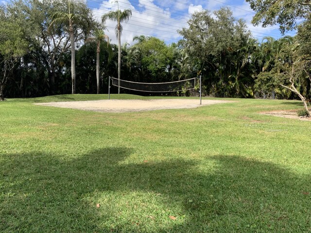 view of home's community with a lawn and volleyball court