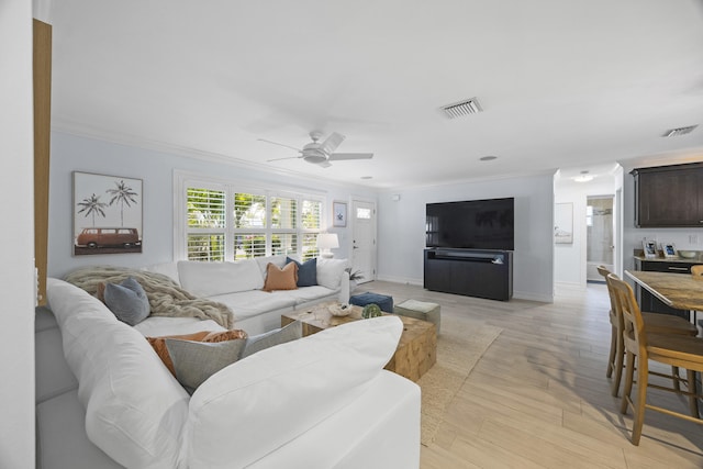 living room featuring light hardwood / wood-style flooring, ornamental molding, and ceiling fan