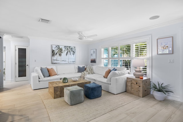 living room with crown molding, ceiling fan, and light hardwood / wood-style floors