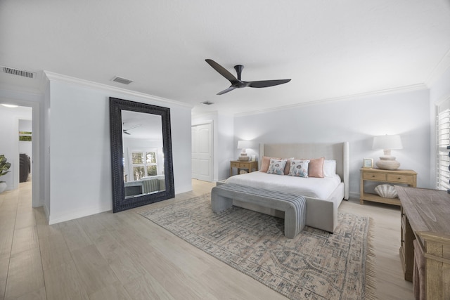 bedroom featuring light hardwood / wood-style flooring, ornamental molding, and ceiling fan