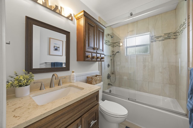 full bathroom featuring vanity, toilet, and combined bath / shower with glass door