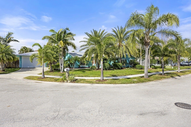 view of front of property featuring a garage and a front lawn