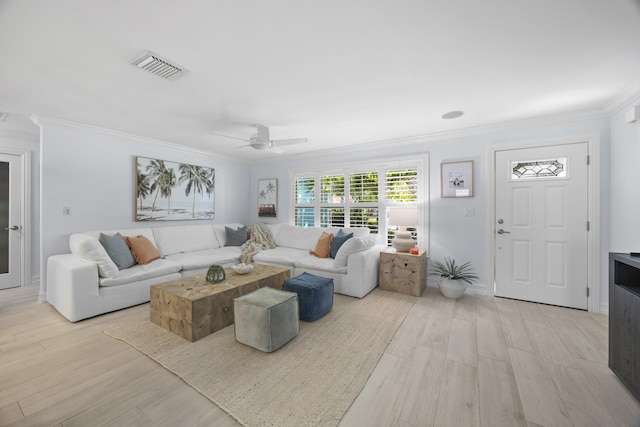 living room with ornamental molding, ceiling fan, and light wood-type flooring