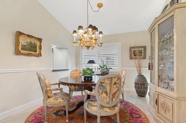 dining room with lofted ceiling and an inviting chandelier