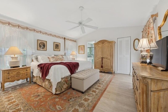 bedroom featuring ceiling fan, lofted ceiling, and light wood-type flooring