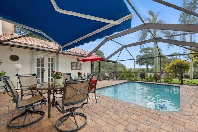 view of swimming pool featuring a patio, french doors, and glass enclosure