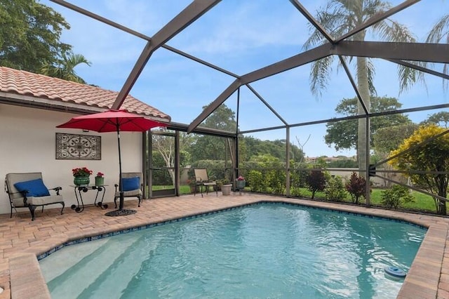 view of swimming pool featuring a patio and glass enclosure