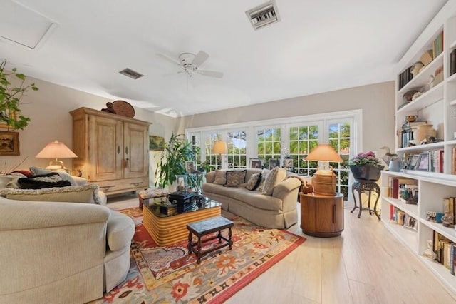 living room with light hardwood / wood-style floors and ceiling fan