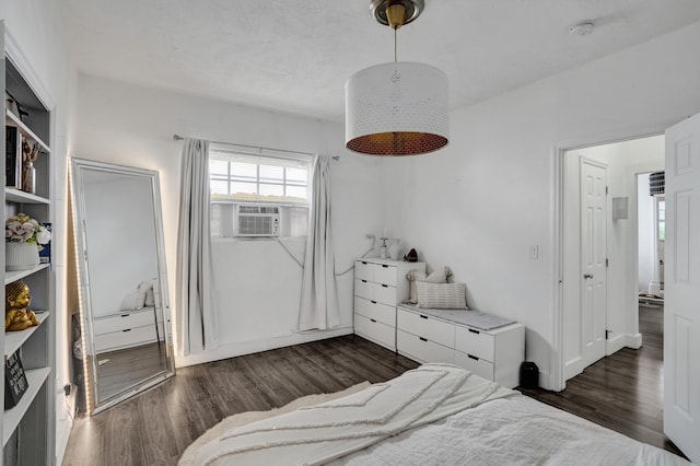 bedroom with dark wood-type flooring and cooling unit