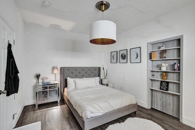 bedroom with dark hardwood / wood-style flooring