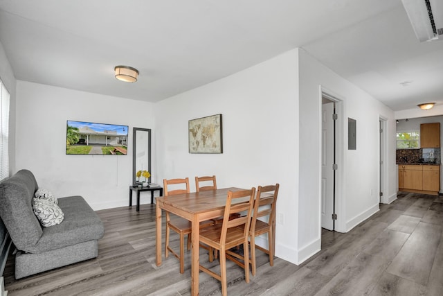 dining space with light hardwood / wood-style floors