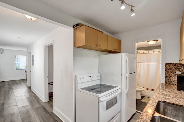 kitchen with white electric stove, wood-type flooring, backsplash, and light brown cabinetry