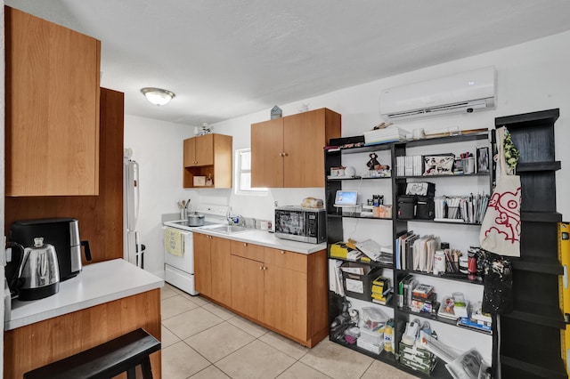 kitchen featuring sink, light tile patterned floors, white appliances, and an AC wall unit