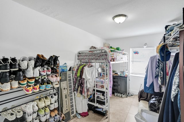 walk in closet with light tile patterned floors