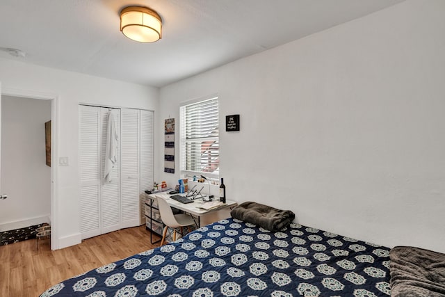 127 NW 47th Ter, Miami, FL 33127 - bedroom with wood finished floors, a closet, and baseboards