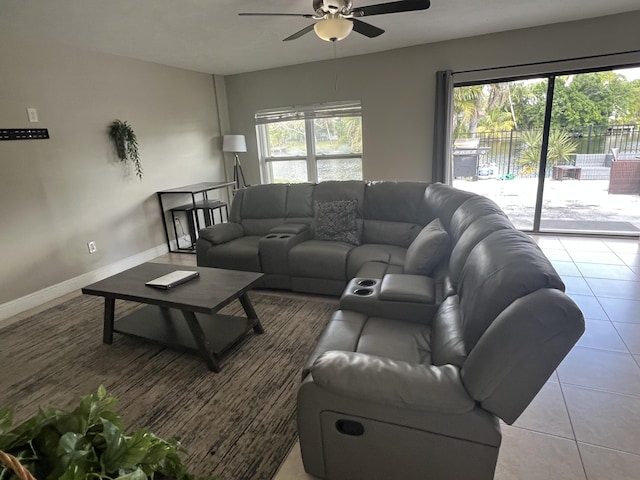 tiled living room featuring ceiling fan and a wealth of natural light