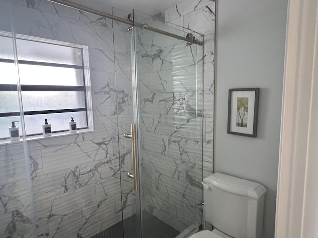 bathroom with walk in shower and toilet